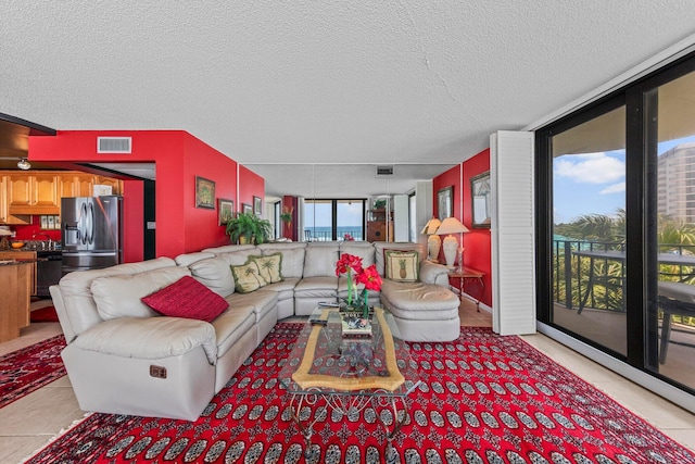 living room featuring a textured ceiling and light tile flooring