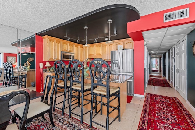 dining space with light tile floors