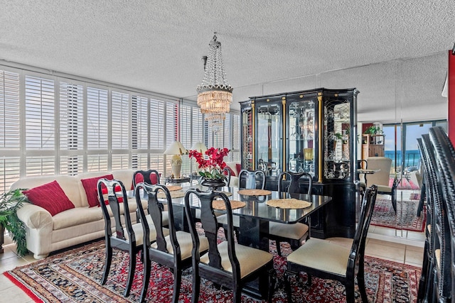 dining room featuring tile flooring, a textured ceiling, and a chandelier