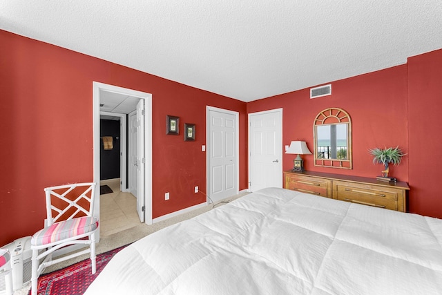 carpeted bedroom with a textured ceiling