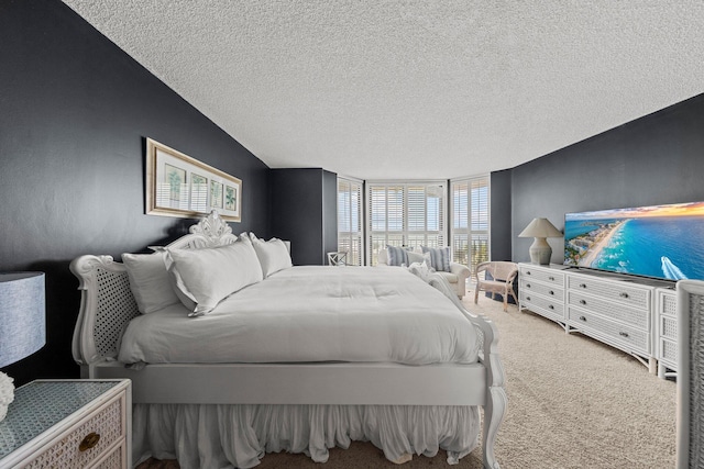 bedroom featuring a textured ceiling and carpet flooring