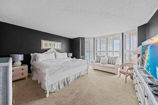 carpeted bedroom featuring a textured ceiling