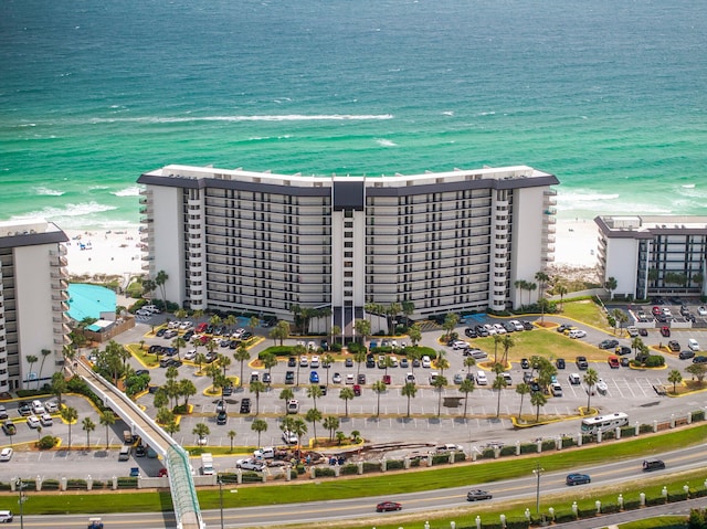 birds eye view of property featuring a beach view and a water view