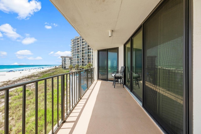 balcony with a view of the beach and a water view