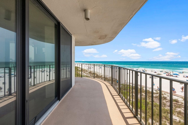 balcony with a beach view and a water view