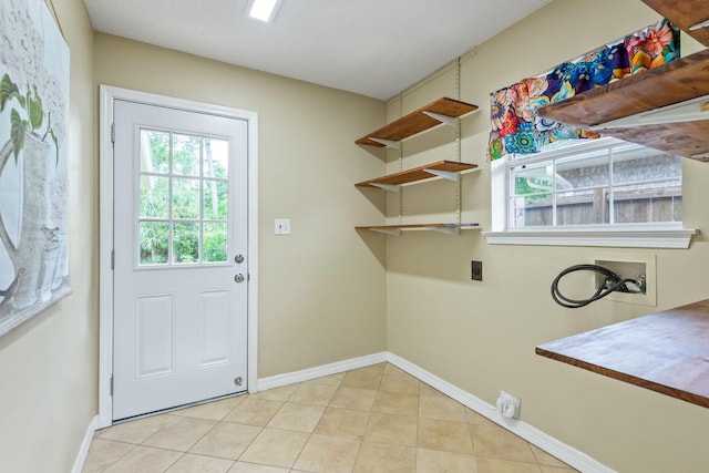 laundry area featuring washer hookup, hookup for an electric dryer, and light tile floors