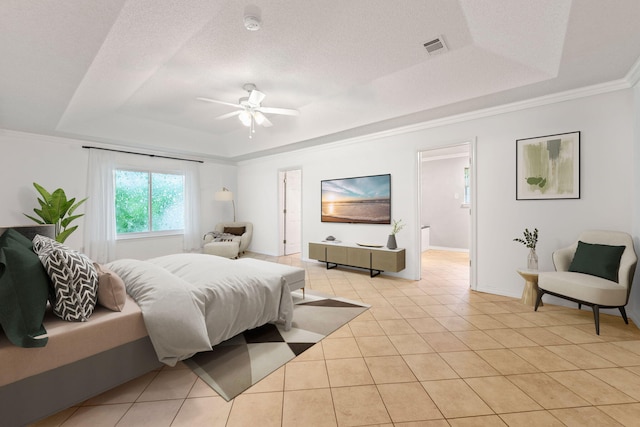 bedroom featuring a tray ceiling, ensuite bathroom, light tile flooring, and ceiling fan