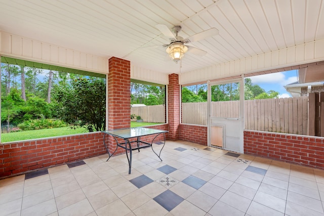 unfurnished sunroom featuring ceiling fan