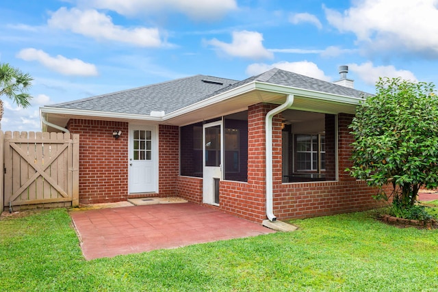 back of house featuring a patio and a yard