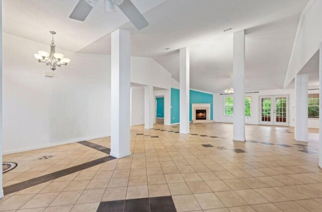 9720 Parker Lake Cir, Navarre, FL 32566 - interior space featuring light tile patterned floors, baseboards, a warm lit fireplace, ceiling fan with notable chandelier, and lofted ceiling