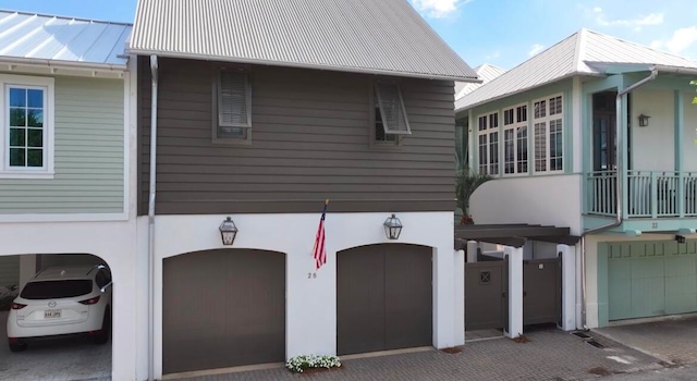 view of front of home featuring a balcony and a garage