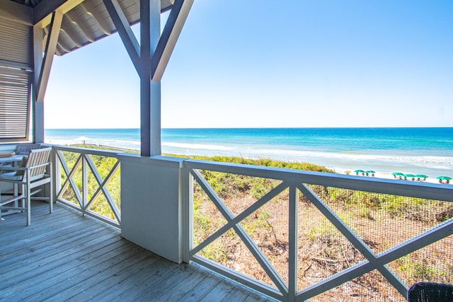 deck featuring a view of the beach and a water view