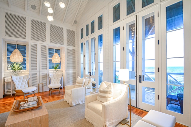 living room featuring a water view, french doors, and plenty of natural light