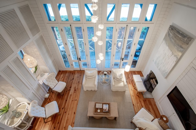 living room featuring wood-type flooring and a high ceiling