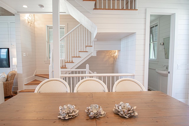 dining room with wooden walls and a wealth of natural light