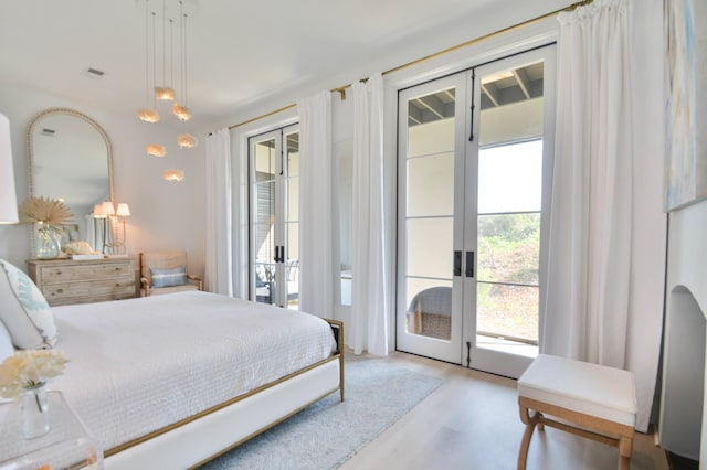 bedroom with french doors, multiple windows, and access to outside