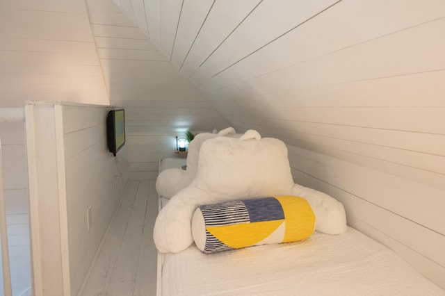 bedroom featuring lofted ceiling and hardwood / wood-style flooring