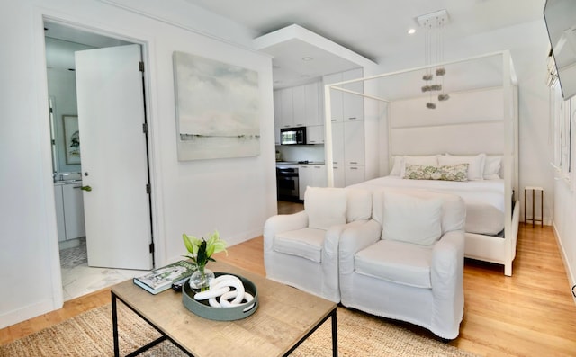 bedroom with light hardwood / wood-style floors and radiator