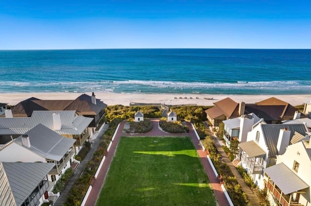 birds eye view of property with a view of the beach and a water view