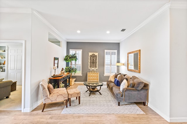 living room with light hardwood / wood-style floors and crown molding