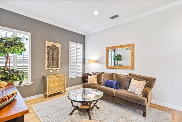 living room with light hardwood / wood-style flooring and ornamental molding