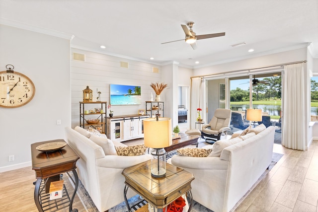 living room with ceiling fan and ornamental molding