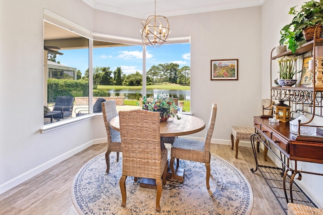 dining area featuring plenty of natural light, a water view, and a notable chandelier