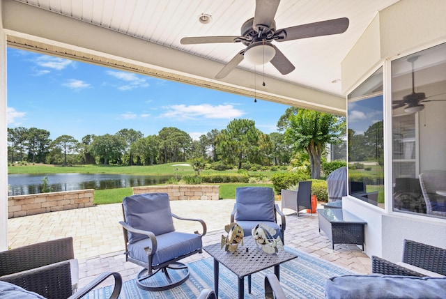 view of patio / terrace with ceiling fan and a water view