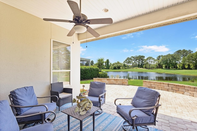 view of patio / terrace featuring outdoor lounge area, ceiling fan, and a water view