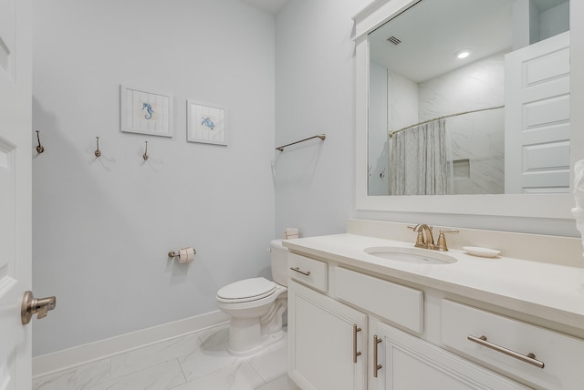 bathroom with vanity with extensive cabinet space, tile flooring, and toilet