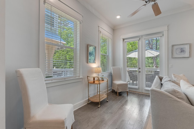 sitting room with ceiling fan, french doors, ornamental molding, and wood-type flooring