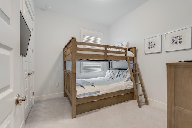 carpeted bedroom featuring lofted ceiling