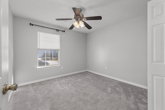 carpeted empty room featuring ceiling fan and a textured ceiling