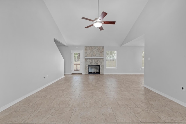 unfurnished living room with a fireplace, high vaulted ceiling, and ceiling fan