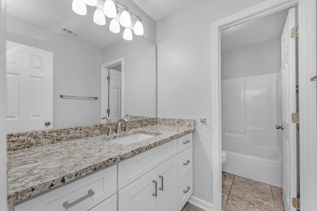 full bathroom with bathing tub / shower combination, vanity, a textured ceiling, and toilet