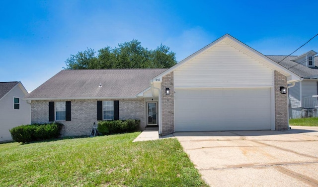 ranch-style home featuring a front lawn and a garage