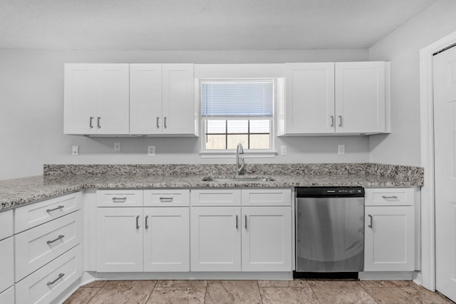 kitchen with light stone counters, a textured ceiling, sink, dishwasher, and white cabinetry