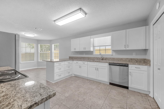 kitchen with kitchen peninsula, sink, white cabinets, and appliances with stainless steel finishes