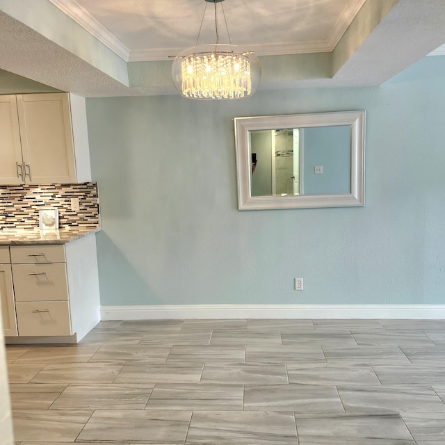 unfurnished dining area featuring a raised ceiling and crown molding