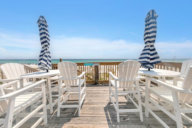 surrounding community featuring a water view and a view of the beach