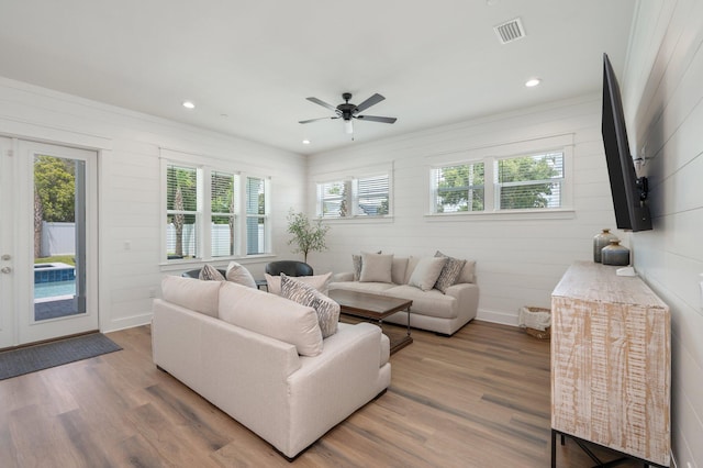 living room featuring ceiling fan and wood-type flooring