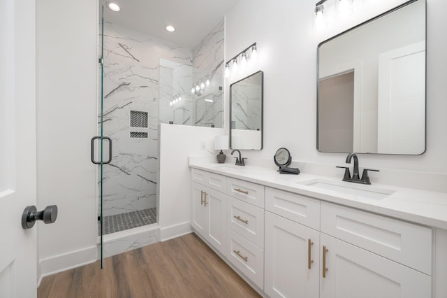 bathroom featuring vanity, hardwood / wood-style flooring, and an enclosed shower