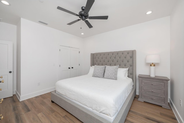 bedroom with ceiling fan, a closet, and dark hardwood / wood-style floors