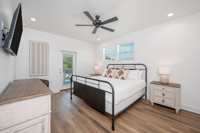 bedroom featuring access to exterior, ceiling fan, and dark wood-type flooring