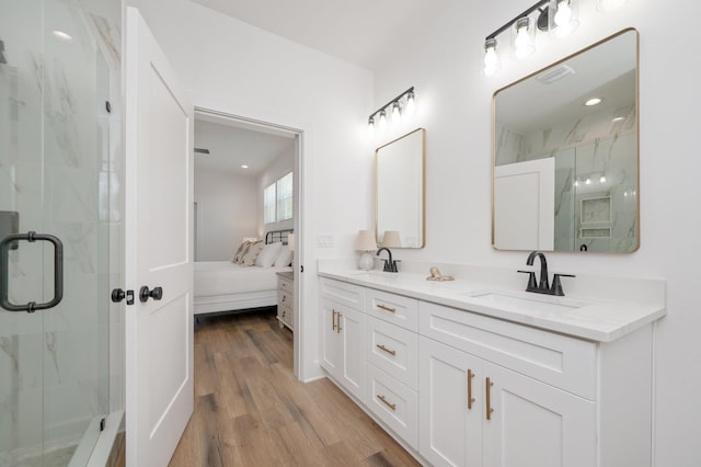 bathroom with vanity, wood-type flooring, and walk in shower