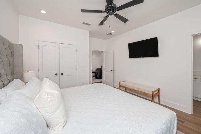 bedroom with a closet, dark hardwood / wood-style floors, and ceiling fan