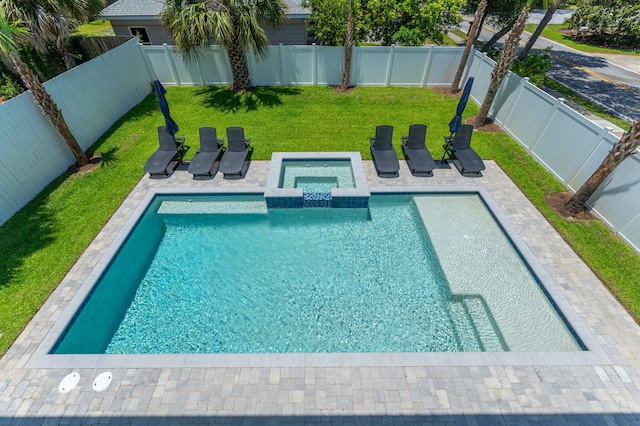 view of pool featuring a lawn and an in ground hot tub