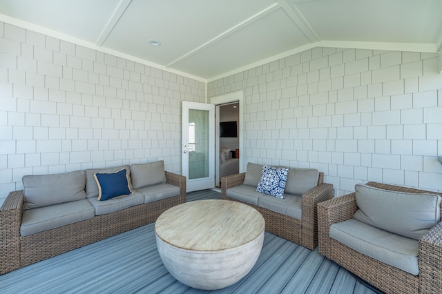 living room with tile walls and lofted ceiling