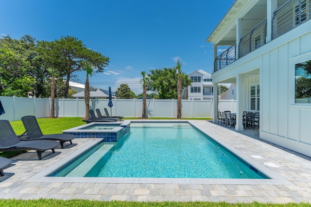 view of pool with an in ground hot tub and a patio