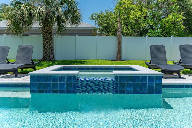 view of swimming pool featuring an in ground hot tub